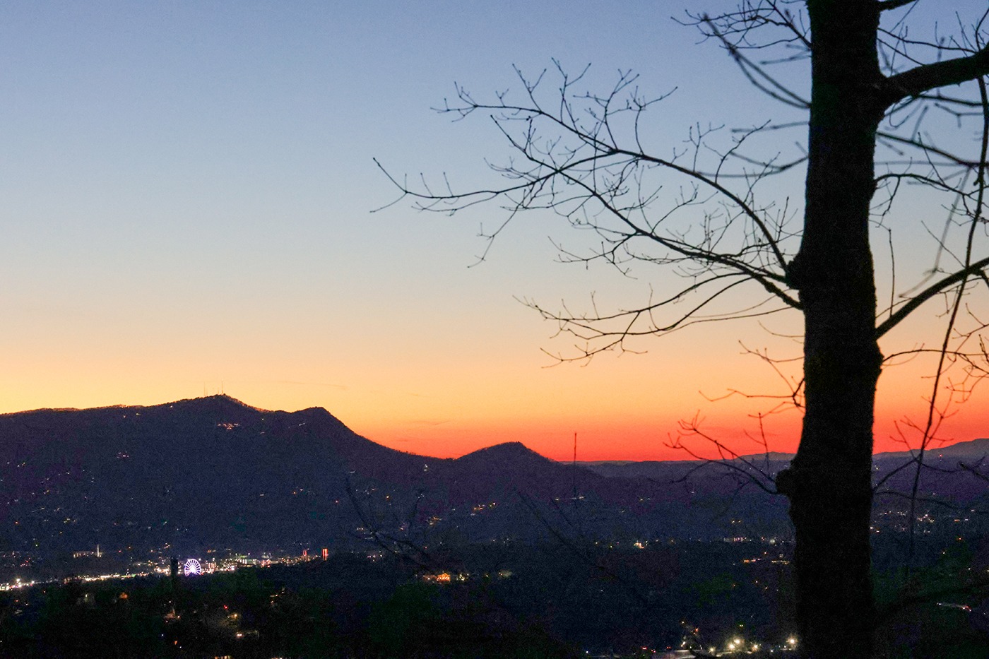 Sunset over mountains with vibrant orange and purple hues,